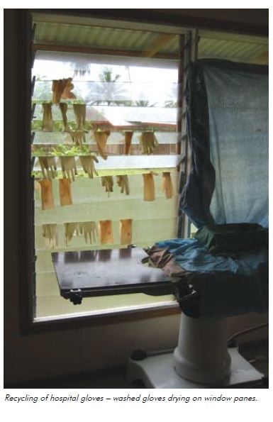Recycling of hospital gloves – washed gloves drying on window panes.