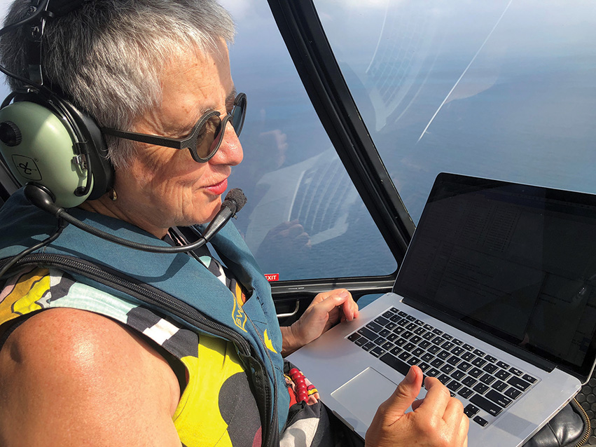 Professor Ruth Stewart in a helicopter flying over Thursday Island.