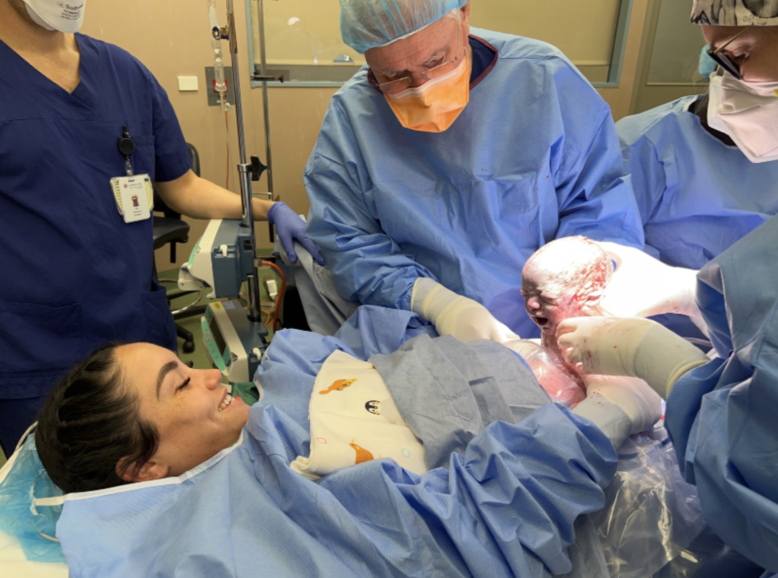 Rebecca Hamilton meets her baby after a successful maternally assisted caesarean.