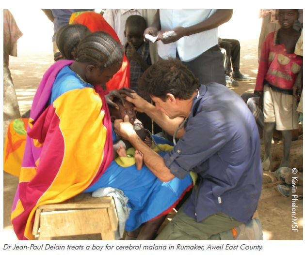 Dr Jean-Paul Delain treats a boy for cerebral malaria in Rumaker, Aweil East County, whilst volunteering for Médecins Sans Frontières.