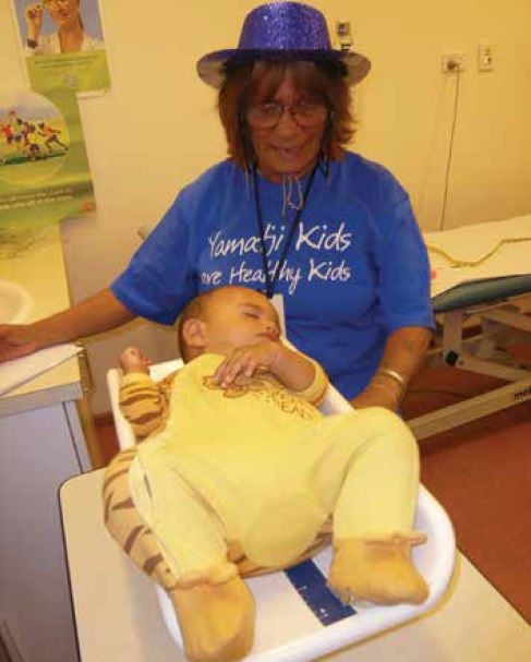 Margie, Aboriginal health worker, and child at a recent child health day held at GRAMS.