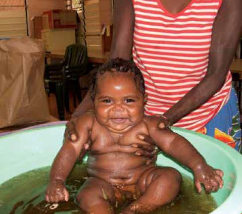 A healthy and happy mother and baby: the end goal for everyone working at the MGP. This baby is enjoying his bath in traditional bush medicine.